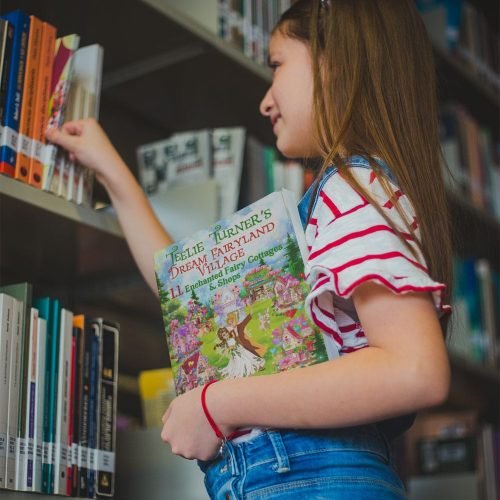 girl-looking-for-a-book-mockup-while-holding-another-book-a19271 girl-looking-for-a-book-mockup-while-holding-another-book-a19271