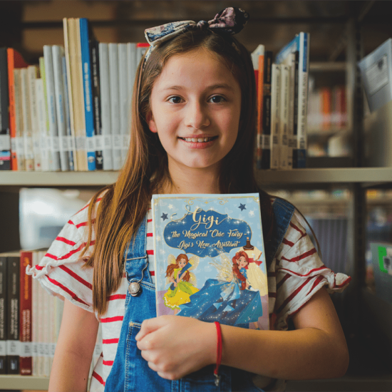 happy-little-girl-holding-a-book-mockup-at-the-library-a19273-(1)-min happy-little-girl-holding-a-book-mockup-at-the-library-a19273-(1)-min