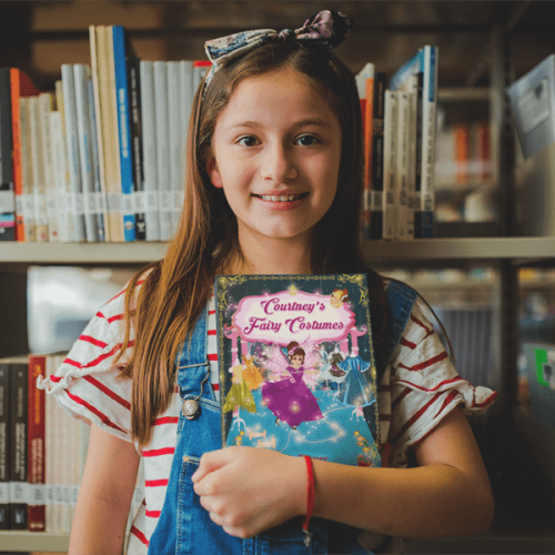 happy-little-girl-holding-a-book-mockup-at-the-library-a19273-min-min happy-little-girl-holding-a-book-mockup-at-the-library-a19273-min-min